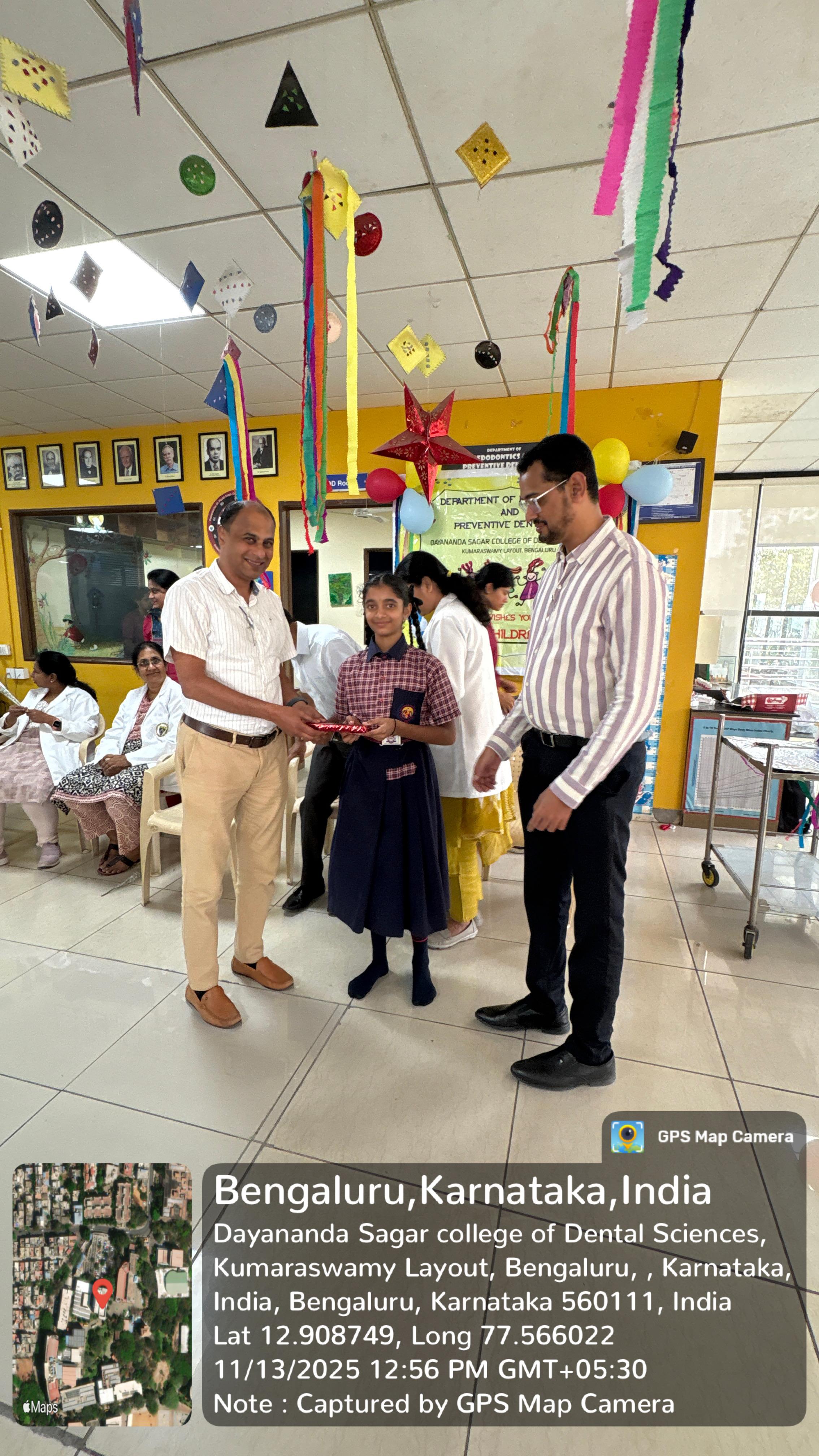 Student receiving a prize or gift from a faculty member